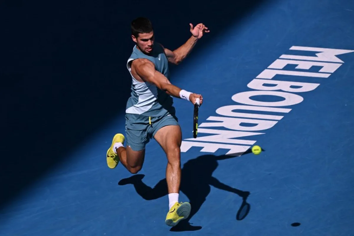 Spain's Carlos Alcaraz hits a shot against Britain's Jack Draper during their men's singles match on day eight of the Australian Open tennis tournament in Melbourne on January 19, 2025.  WILLIAM WEST / AFP