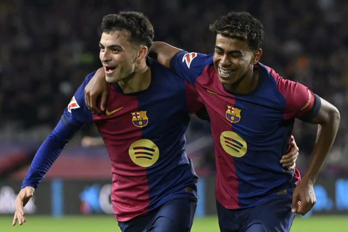 Barcelona's Spanish midfielder #08 Pedri celebrates scoring his team's second goal, with Barcelona's Spanish forward #19 Lamine Yamal, during the Spanish league football match between FC Barcelona and Sevilla FC at the Estadi Olimpic Lluis Companys in Barcelona on October 20, 2024.  Josep LAGO / AFP