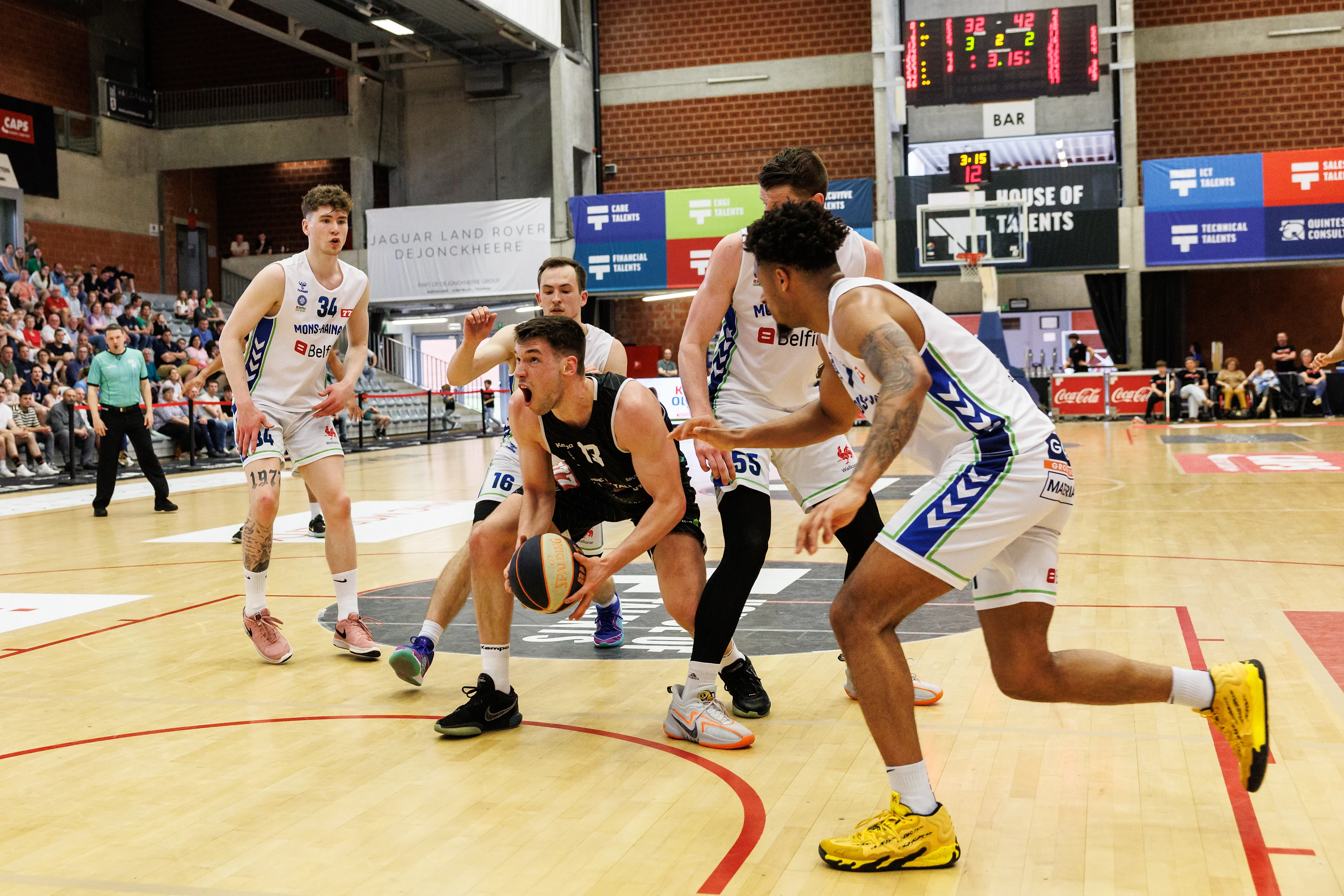 Kortrijk's Niels De Ridder, Mons' Zaccharie Mortant and Mons' Leon Santelj fight for the ball during a basketball match between Spurs Kortrijk (Belgium) and Mons-Hainaut (Belgium), Wednesday 01 May 2024 in Kortrijk, on day 9 (out of 10) in the 'Elite Silver' cross-boarder phase of the 'BNXT League' Belgian and Netherlands first division basket championship. BELGA PHOTO KURT DESPLENTER