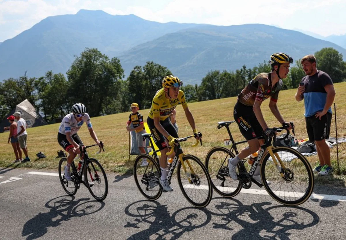 UAE Team Emirates team's Slovenian rider Tadej Pogacar (L) wearing the best young rider's white jersey, Jumbo-Visma team's Danish rider Jonas Vingegaard wearing the overall leader's yellow jersey and Jumbo-Visma team's American rider Sepp Kuss cycle during the final kilometers of the 18th stage of the 109th edition of the Tour de France cycling race, 143,2 km between Lourdes and Hautacam in the Pyrenees mountains in southwestern France, on July 21, 2022. Thomas SAMSON / AFP