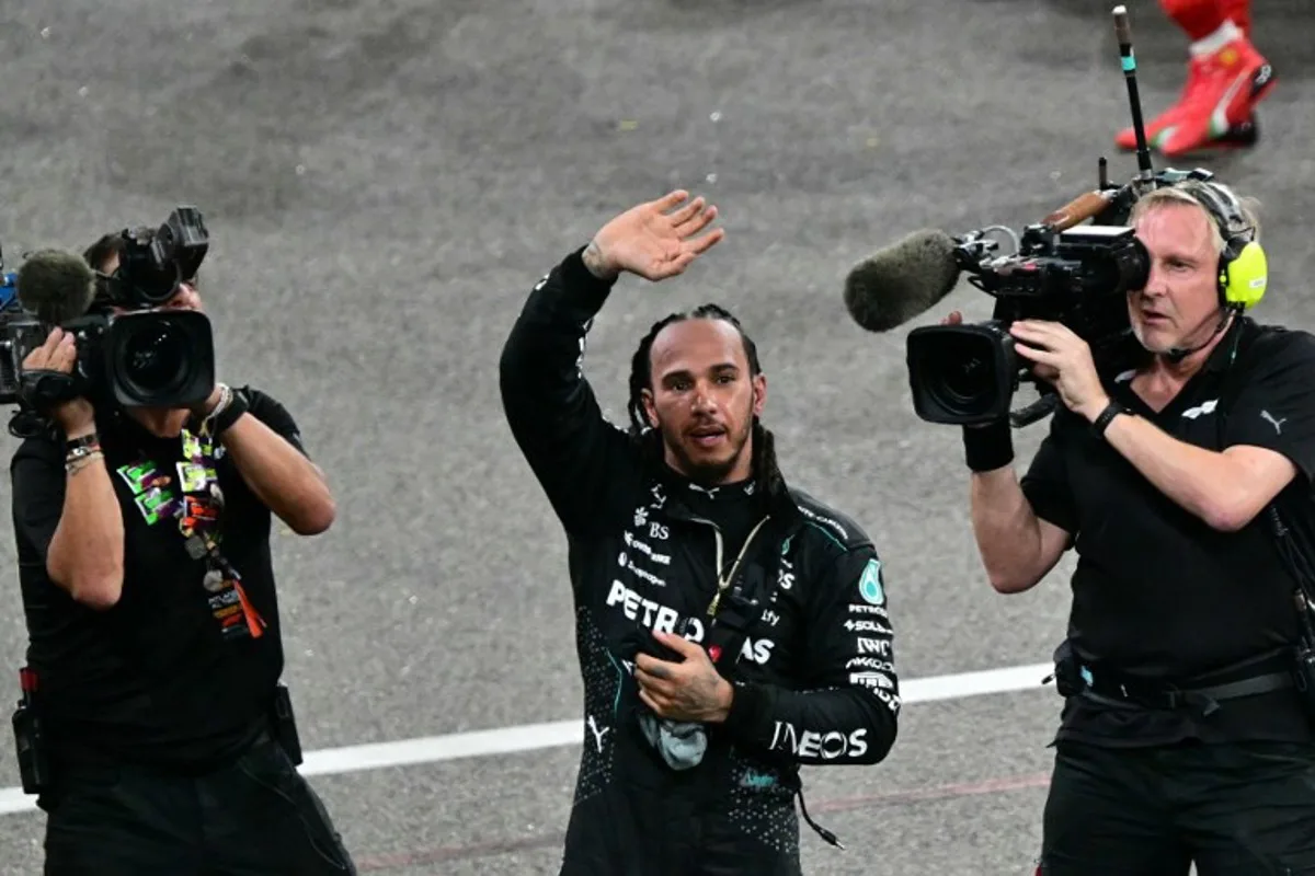 Mercedes' British driver Lewis Hamilton greets the fans after the Abu Dhabi Formula One Grand Prix at the Yas Marina Circuit in Abu Dhabi on December 8, 2024.  Giuseppe CACACE / AFP