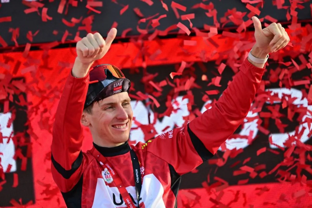 Leader of the race, UAE Team Emirates' Slovenian rider Tadej Pogacar celebrates on the podium at the end of the sixth stage of the UAE Cycling Tour UCI 2025 in Abu Dhabi on February 22, 2025.  Giuseppe CACACE / AFP