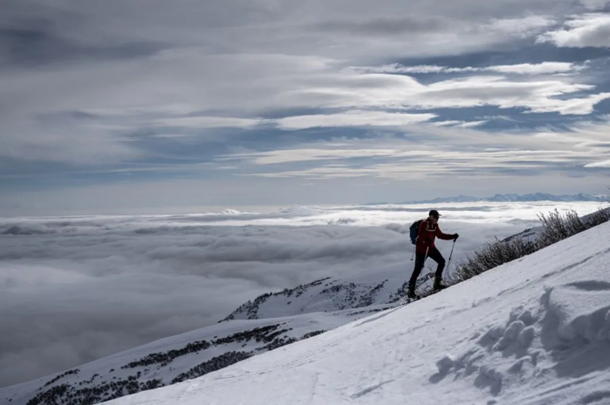 A person practices ski mountaineering in the Monviso Natural Park UNESCO in Paesana, near Cuneo, Northwestern Italy, on February 13, 2025.  Ski mountaineering becomes an Olympic discipline for the next winter Olympics Milano Cortina 2026. MARCO BERTORELLO / AFP