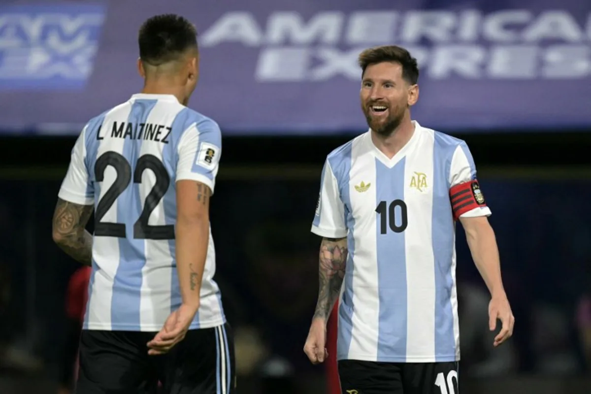 Argentina's forward #22 Lautaro Martinez celebrates with Argentina's forward #10 Lionel Messi after scoring during the 2026 FIFA World Cup South American qualifiers football match between Argentina and Peru at the La Bombonera stadium in Buenos Aires on November 19, 2024.  JUAN MABROMATA / AFP