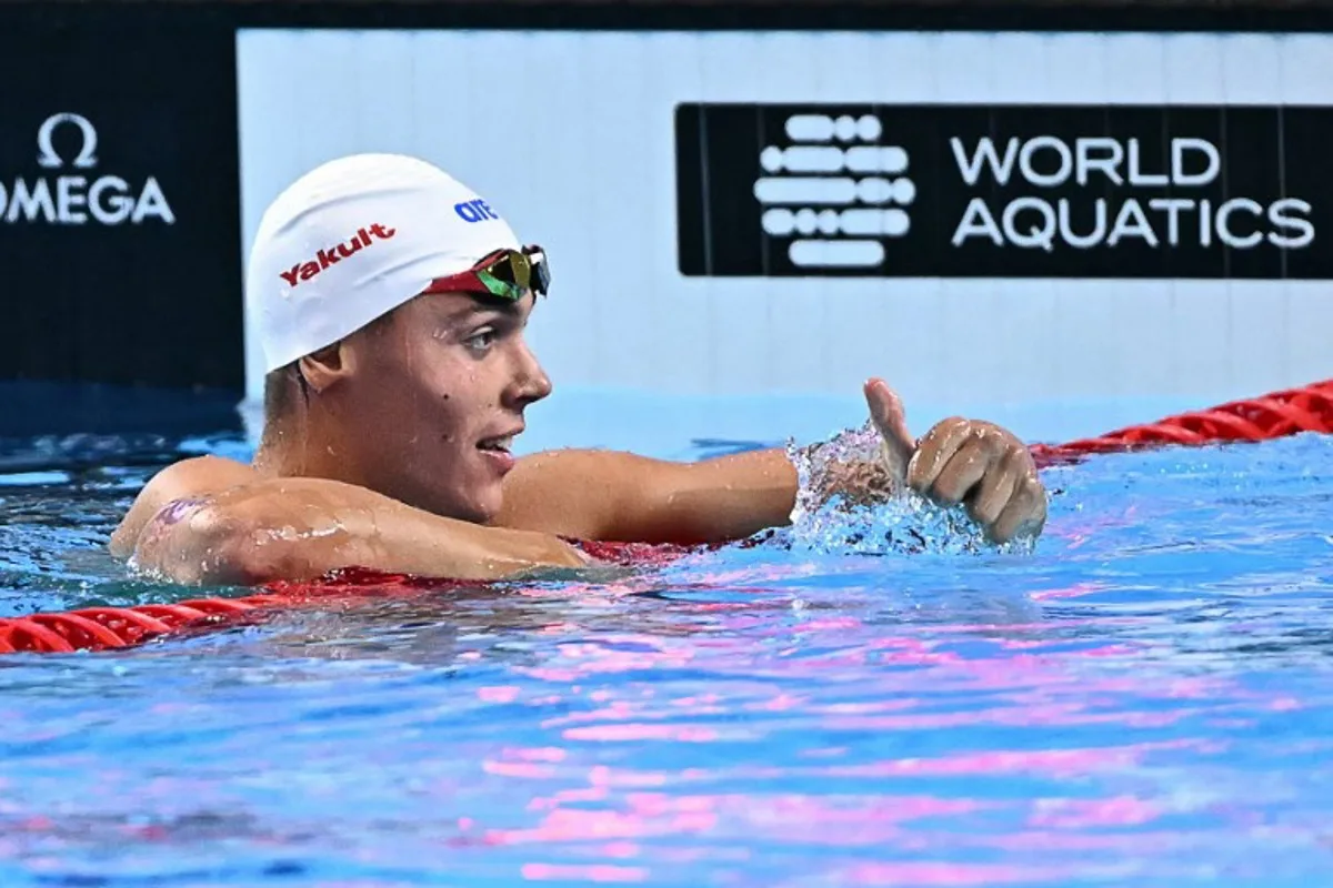 Romania's swimmer David Popovici reacts after competing a semi-final of the men's 100m freestyle swimming event during the 2025 World Aquatics Championships in Singapore on July 30, 2025. MANAN VATSYAYANA / AFP