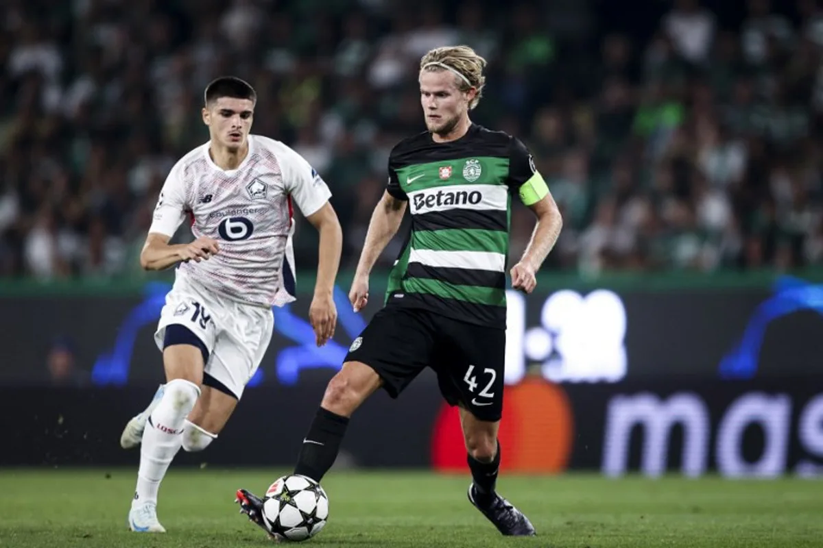 Sporting Lisbon's Danish midfielder Morten Hjulmand #42 fights for the ball with Lille's Belgian forward Mathias Fernandez-Pardo #19 during the UEFA Champions League 1st round day 1 football match between Sporting CP and LOSC Lille, at Alvalade stadium in Lisbon, on September 17, 2024.  FILIPE AMORIM / AFP