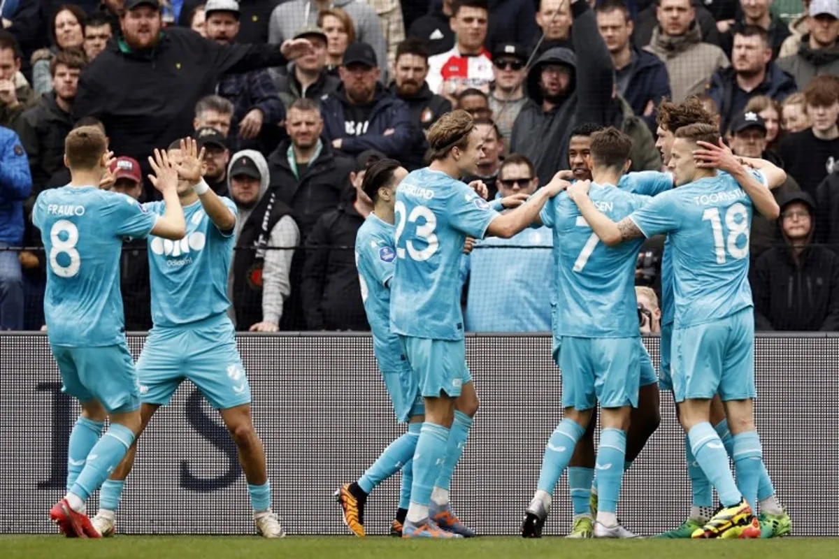 Utrecht's players celebrate scoring their second goal during the Dutch Eredivisie football match between Feyenoord and FC Utrecht at the Feyenoord "De Kuip" stadium in Rotterdam, on March 31, 2024.  MAURICE VAN STEEN / ANP / AFP