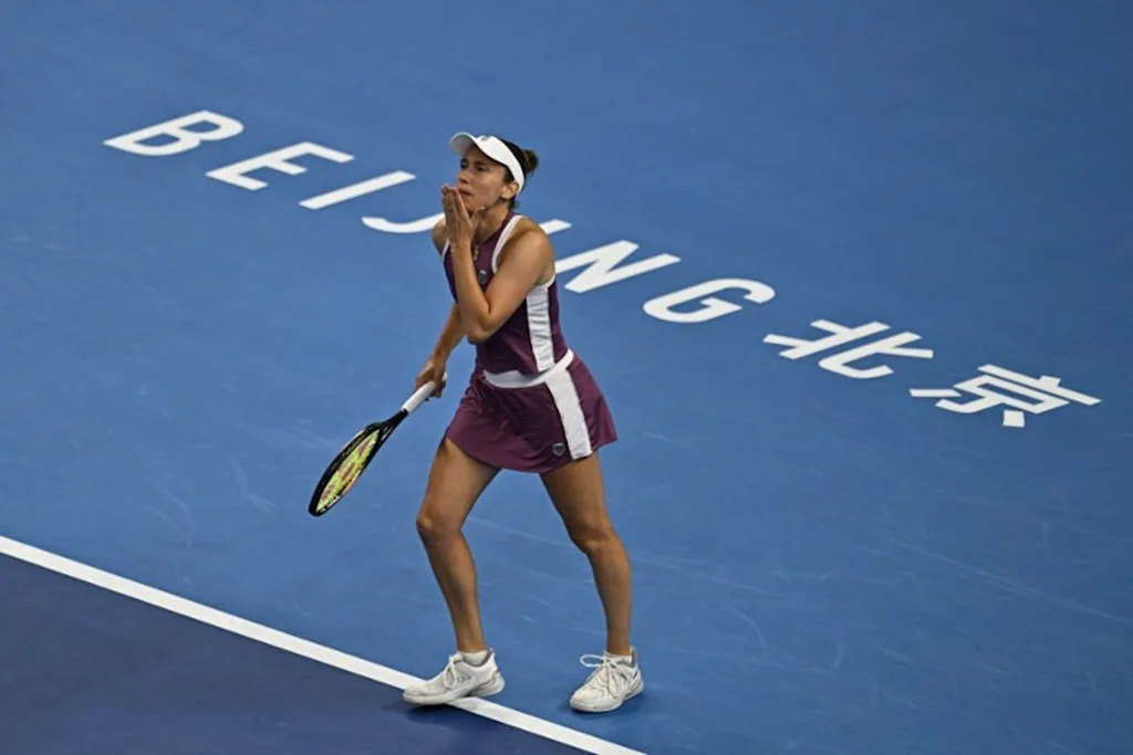 Belgium's Elise Mertens reacts after winning her women's singles quarter-final match against Poland's Iga Swiatek at the China Open tennis tournament in Beijing on October 9, 2026. Pedro Pardo / AFP