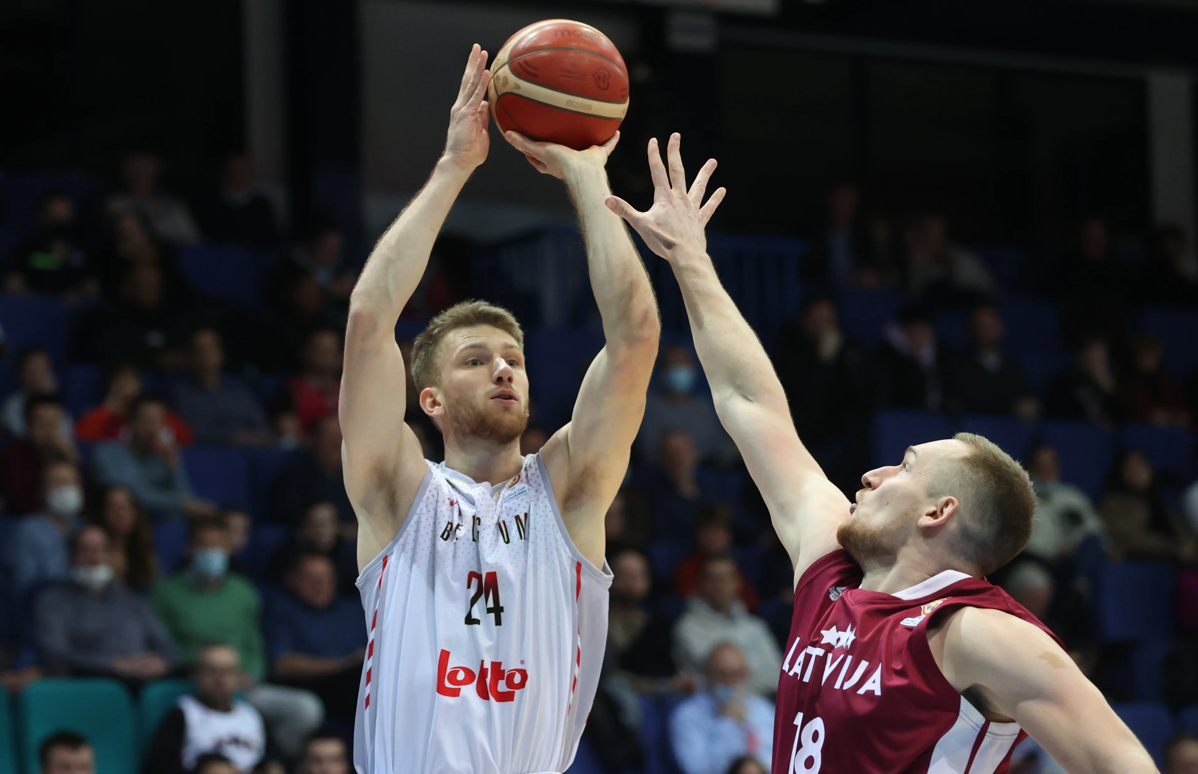 Belgium's Andy Vanvliet and Latvian Klavs Cavars fight for the ball during a match between the Belgian national men team 'the Belgian Lions' and Latvia, a qualifier match in Group A, ahead of the World Cup Basketball, Friday 25 February 2022, in Mons. BELGA PHOTO VIRGINIE LEFOUR