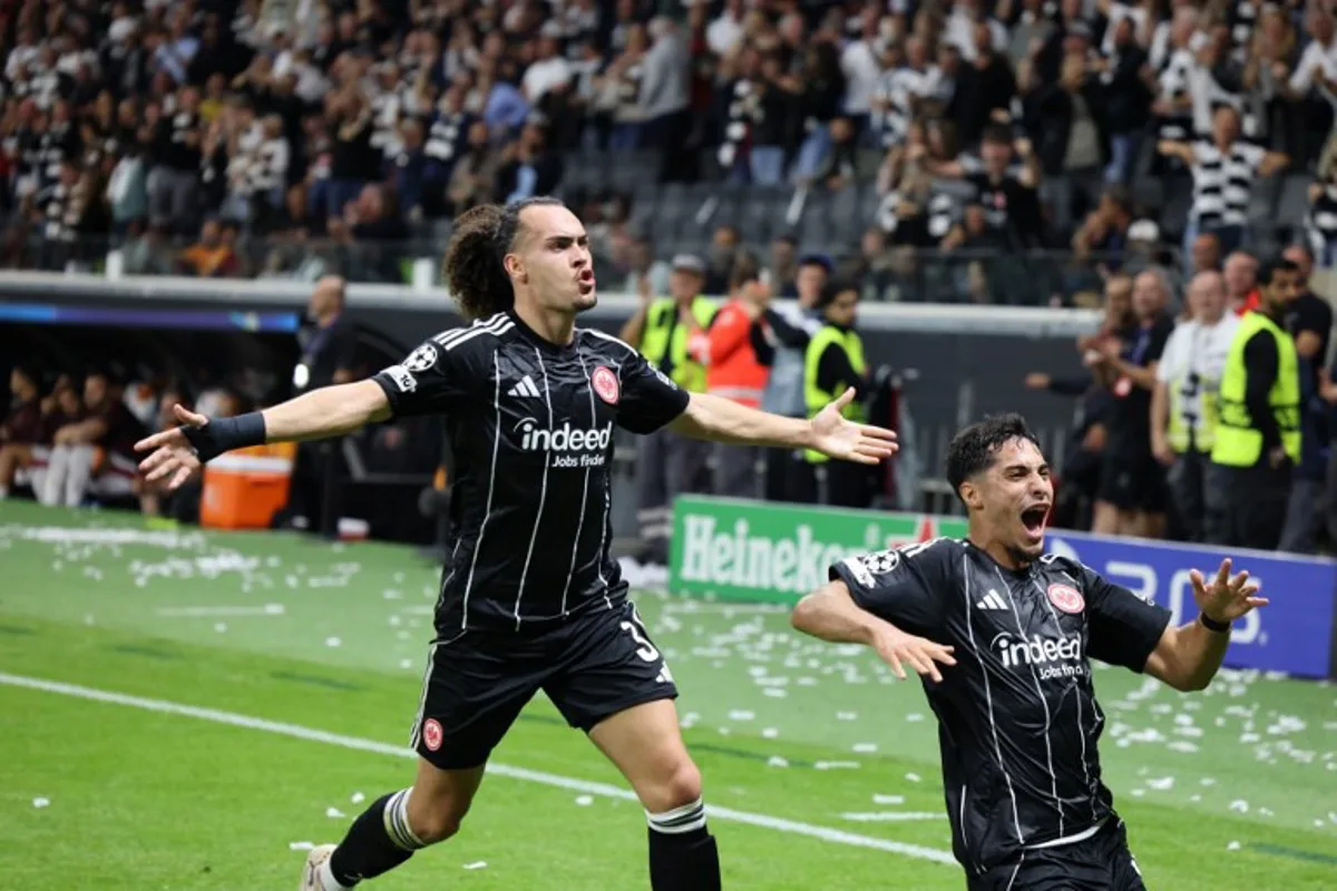 Frankfurt's Algerian midfielder #08 Fares Chaibi (R) and Frankfurt's Belgian defender #03 Arthur Theate celebrate during the UEFA Champions League league phase day 1 football match between Eintracht Frankfurt and Galatasaray in Frankfurt, western Germany on September 18, 2025. Daniel ROLAND / AFP