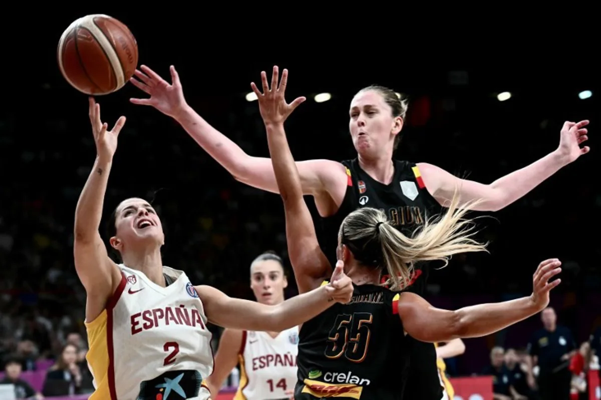 Spain's guard Elena Buenavida (L) attempts a lay-up during the FIBA Women's EuroBasket 2025 final match between Spain and Belgium at the Peace and Friendship Stadium in Athens on June 29, 2025. Angelos Tzortzinis / AFP