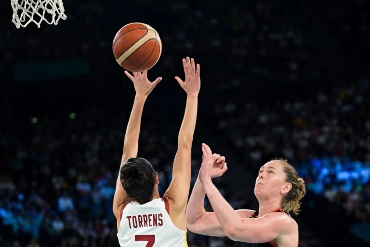 Spain's #07 Alba Torrens blocks the ball against Belgium's #11 Emma Meesseman in the women's quarterfinal basketball match between Spain and Belgium during the Paris 2024 Olympic Games at the Bercy Arena in Paris on August 7, 2024. Damien MEYER / AFP