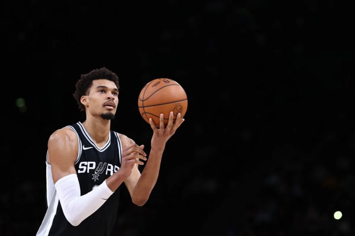 San Antonio Spurs' French forward-center #01 Victor Wembanyama aims a throw  during the NBA basketball game between the San Antonio Spurs and the Indiana Pacers at the Accor Arena - Palais Omnisports de Paris-Bercy - in Paris on January 25, 2025.  FRANCK FIFE / AFP