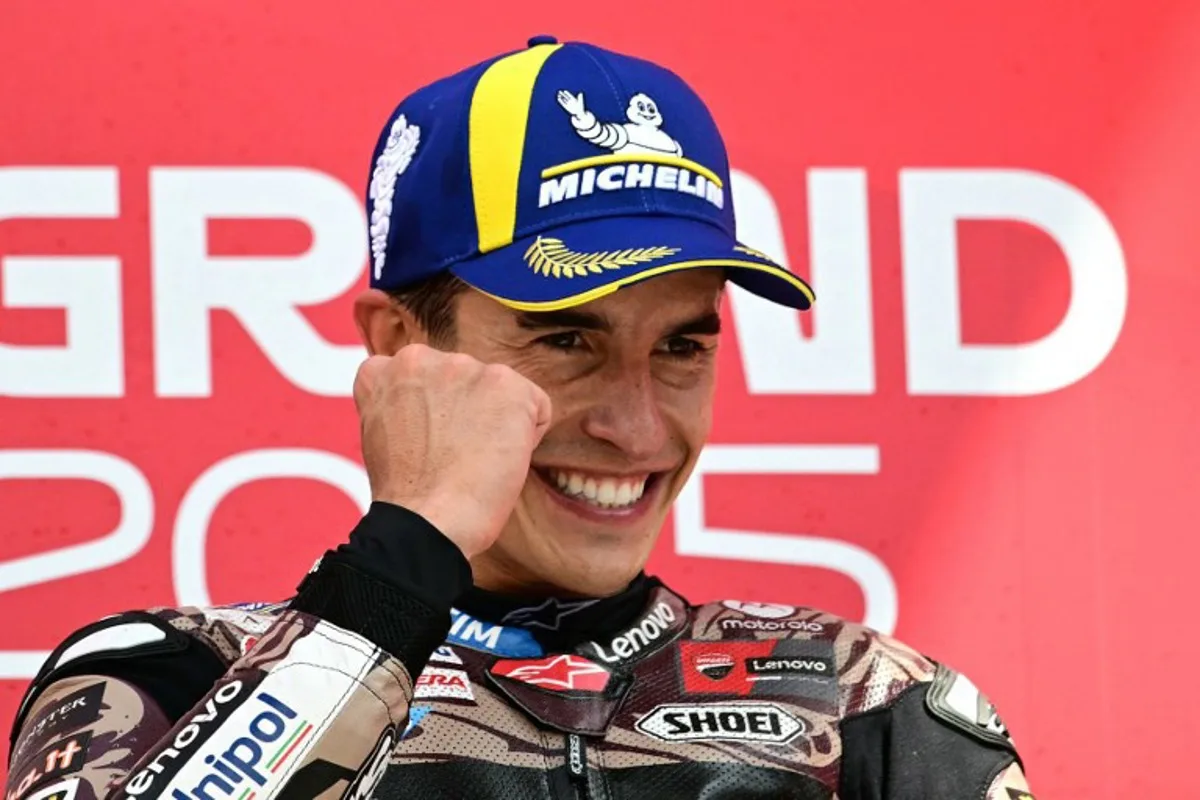 Ducati Lenovoi Team's Spanish MotoGP rider Marc Marquez celebrates first place on the podium after the Italian Moto GP Grand Prix at Mugello circuit, in Mugello, near Florence, on June 22, 2025. Tiziana FABI / AFP