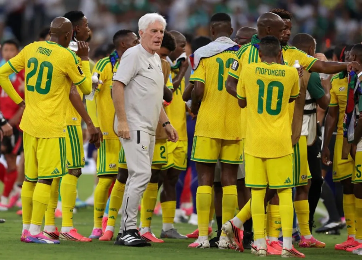 South Africa's Belgian head coach Hugo Broos talks to his players  during a hydration break of the 2026 World Cup Group A football match between South Africa and South Korea at the Monterrey Stadium in Guadalupe, Mexico, on June 24, 2026.   Julio Cesar AGUILAR / AFP
