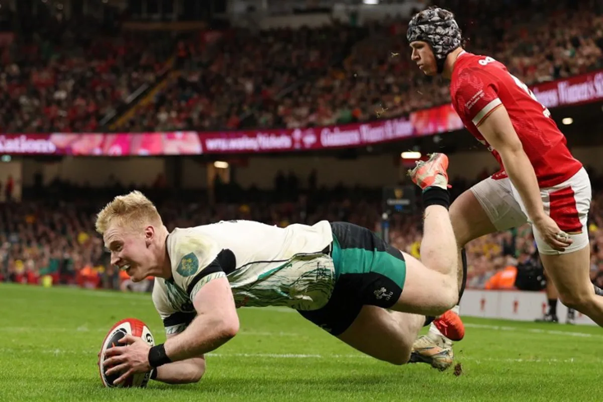 Ireland's full-back Jamie Osborne dives over the line to score a try during the Six Nations international rugby union match between Wales and Ireland at the Principality Stadium in Cardiff, south Wales, on February 22, 2025.  Adrian Dennis / AFP