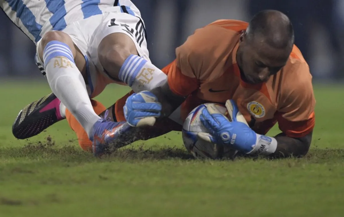 Curacao's goalkeeper Eloy Room (R) vies for the ball with Argentina's forward Nicolas Gonzalez during the friendly football match between Argentina and Curacao at the Madre de Ciudades stadium in Santiago del Estero, in northern Argentina, on March 28, 2023. JUAN MABROMATA / AFP