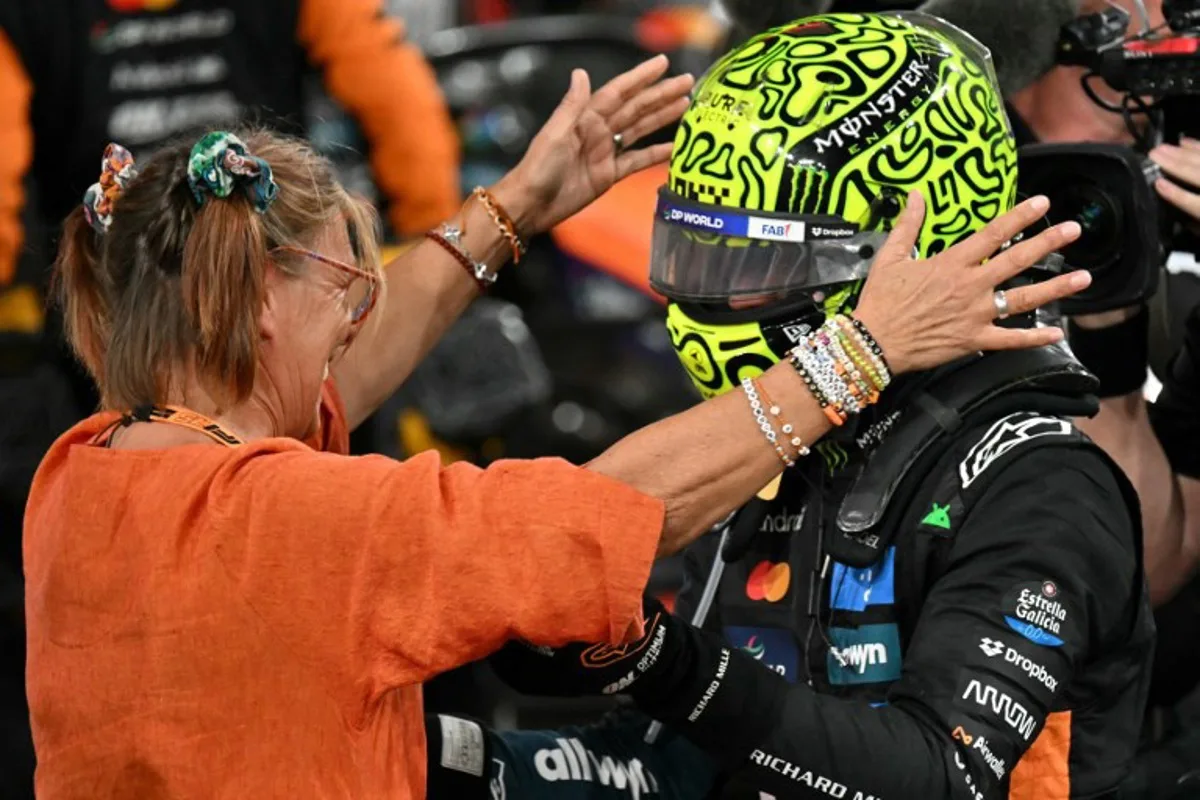 McLaren's British driver Lando Norris (R) celebrates with his family member after finishing the race third to win the world championship title at the end of the Abu Dhabi Formula One Grand Prix at the Yas Marina Circuit in Abu Dhabi on December 7, 2025. Andrej ISAKOVIC / AFP