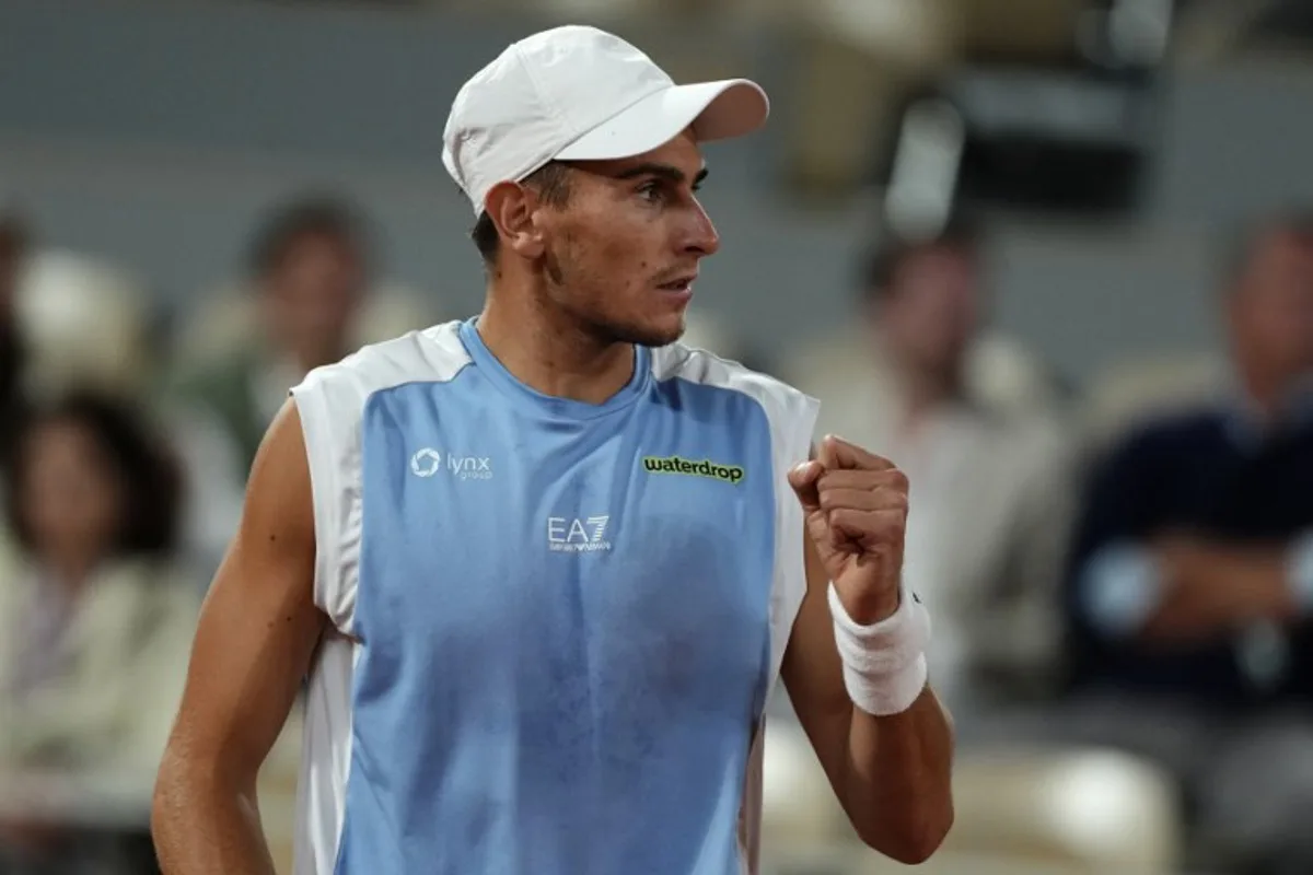 Italy's Matteo Arnaldi reacts to a point against Italy's Matteo Berrettini during their men's quarter final singles match on day 11 of the French Open tennis tournament on Court Philippe-Chatrier at the Roland-Garros Complex in Paris on June 3, 2026.  Dimitar DILKOFF / AFP