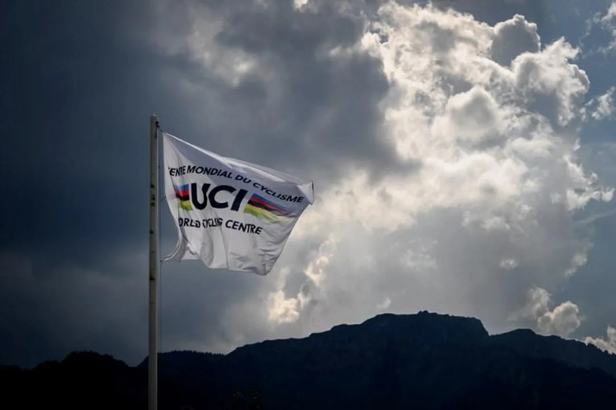 This photo taken on August 10, 2020, shows a flag of the UCI (International Cycling Union) floating under heavy clouds next to the headquarters of the world's cycling governing body in Aigle amid the COVID-19 outbreak, caused by the novel coronavirus. The cycling world championships scheduled for Aigle-Martigny in Switzerland on September 20-27, 2020, might be called off due to local health rules organisers warned on August 7. Swiss federal authorities are due to examine their rules on August 12, and may ban sports gatherings involving more than 1,000 people. Fabrice COFFRINI / AFP