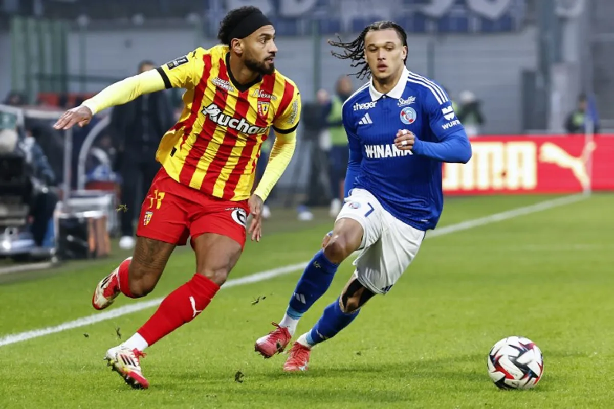 Strasbourg' forward #7 Diego Moreira fights for the ball with Lens' midfielder #11 Angelo Fulgini during the French L1 football match between RC Lens and RC Strasbourg at Stade Bollaert-Delelis in Lens, northern France on February 16, 2025.  DENIS CHARLET / AFP