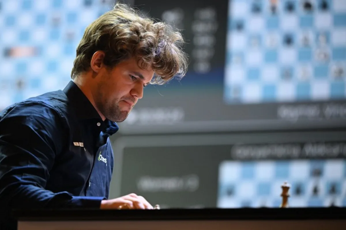 Norway's chess grandmaster Magnus Carlsen gestures during a game in the Tata Steel Chess India tournament in Kolkata on November 17, 2024.  DIBYANGSHU SARKAR / AFP