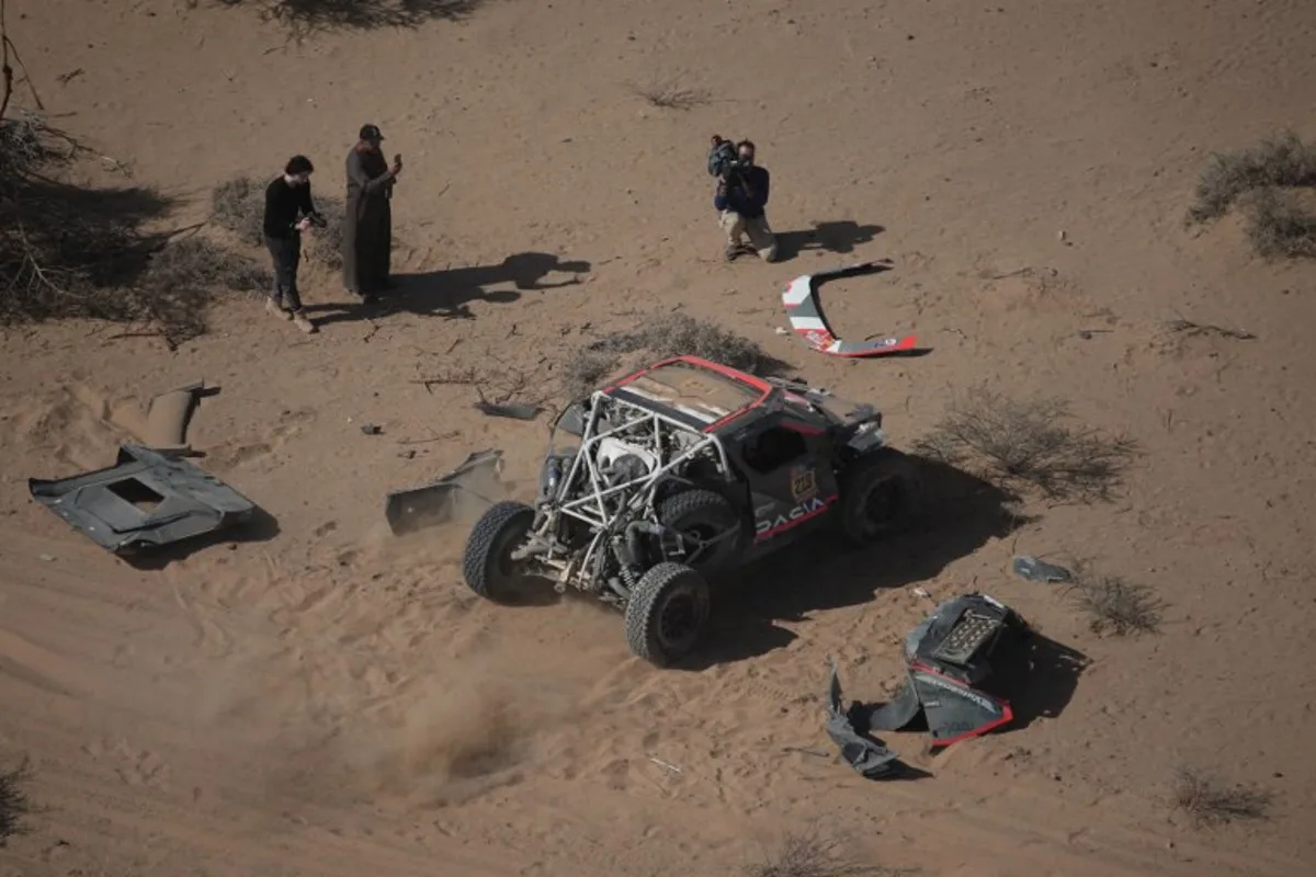 The Dacia of French driver Sebastien Loeb is seen after crashing during stage 3 of the 47th Dakar Rally between Bisha and Al Henakiyah, on January 7, 2025.  Christophe Ena / AFP