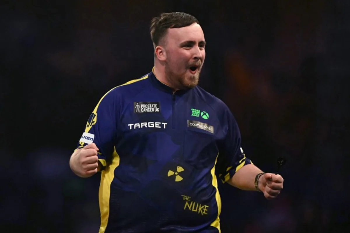 England's Luke Littler celebrates winning the fourth set against Netherlands' Michael van Gerwen during the PDC World Darts Championship final, at Alexandra Palace in London on January 3, 2025. Ben STANSALL / AFP