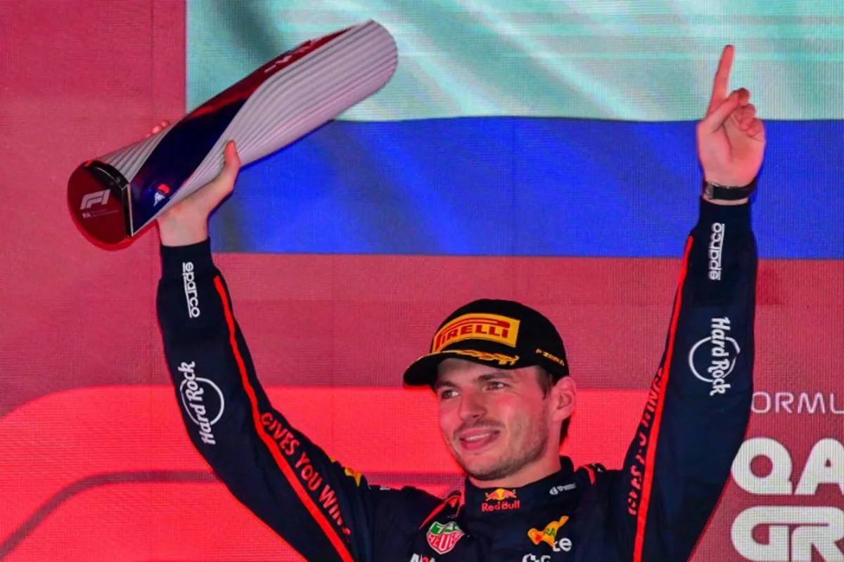 Red Bull Racing's Dutch driver Max Verstappen holds up the trophy on the podium after winning the Formula One Qatar Grand Prix at the Lusail International Circuit in Lusail on November 30, 2025.  Andrej ISAKOVIC / AFP