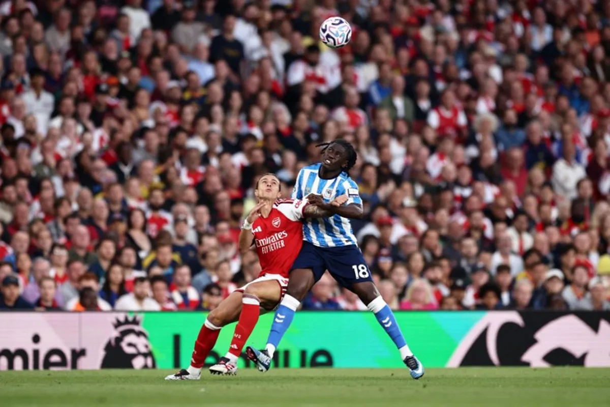 Arsenal's Italian defender #33 Riccardo Calafiori battles for the ball with Coventry City's French midfielder #18 Loum Tchaouna during the English Premier League football match between Arsenal and Coventry City at the Emirates Stadium in London on August 21, 2026. Henry NICHOLLS / AFP