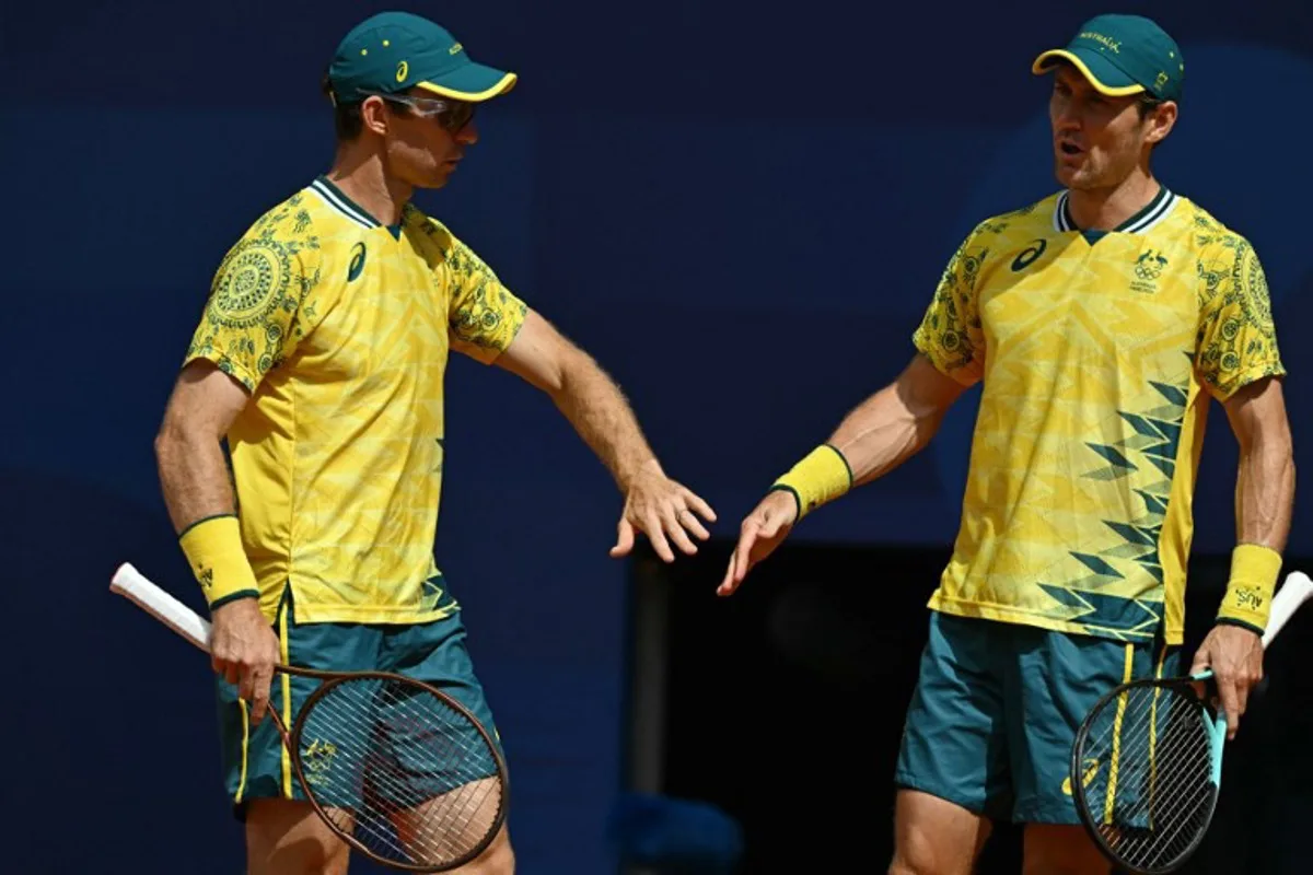 Australia's Matthew Ebden (R) and Australia's John Peers (L) react while playing US' Austin Krajicek and US' Rajeev Ram during their men's doubles final tennis match on Court Philippe-Chatrier at the Roland-Garros Stadium during the Paris 2024 Olympic Games, in Paris on August 3, 2024.   Patricia DE MELO MOREIRA / AFP