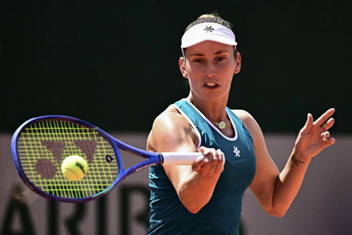 Belgium's Elise Mertens plays a forehand return to Poland's Maja Chwalinska during their women's singles match on day 5 of the French Open tennis tournament at the Roland-Garros Complex in Paris on May 28, 2026.  JULIEN DE ROSA / AFP