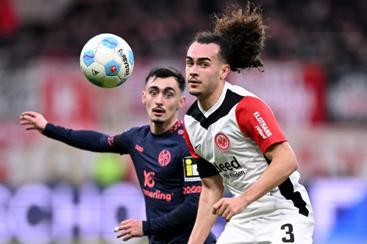 Mainz' German midfielder #08 Paul Nebel (L) vies with Frankfurt's Belgian defender #03 Arthur Theate during the German first division Bundesliga football match between Eintracht Frankfurt and Mainz 05 in Frankfurt on December 21, 2024.  Kirill KUDRYAVTSEV / AFP