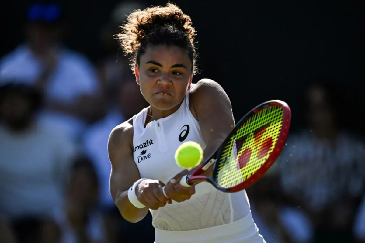 Italy's Jasmine Paolini plays a backhand return to Latvia's Anastasija Sevastova during their women's singles first round tennis match on the first day of the 2025 Wimbledon Championships at The All England Lawn Tennis and Croquet Club in Wimbledon, southwest London, on June 30, 2025. Kirill KUDRYAVTSEV / AFP