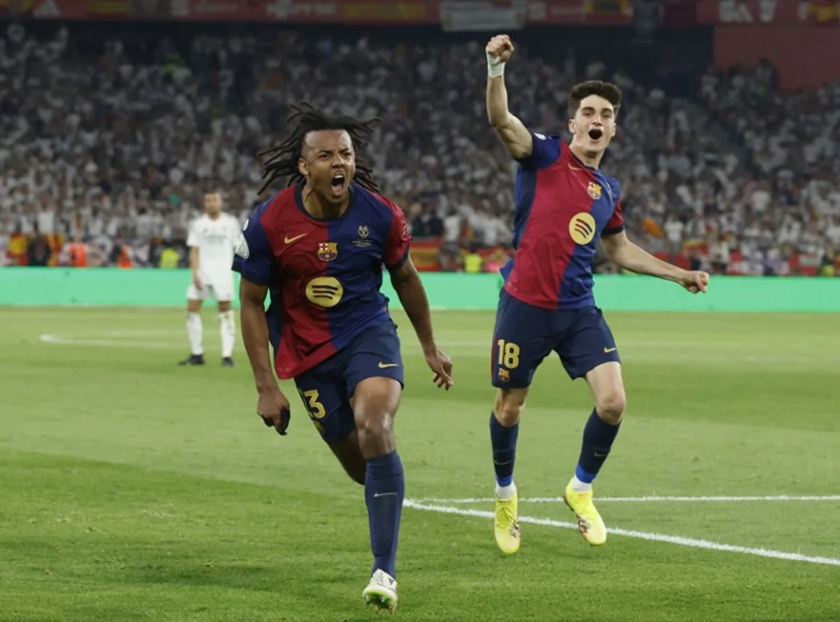 Barcelona's French defender #23 Jules Kounde (L) celebrates scoring his team's third goal during their Spanish Cup, Copa del Rey (King's Cup) final football match between FC Barcelona and Real Madrid CF at La Cartuja stadium in Seville on April 26, 2025. Pierre-Philippe MARCOU / AFP