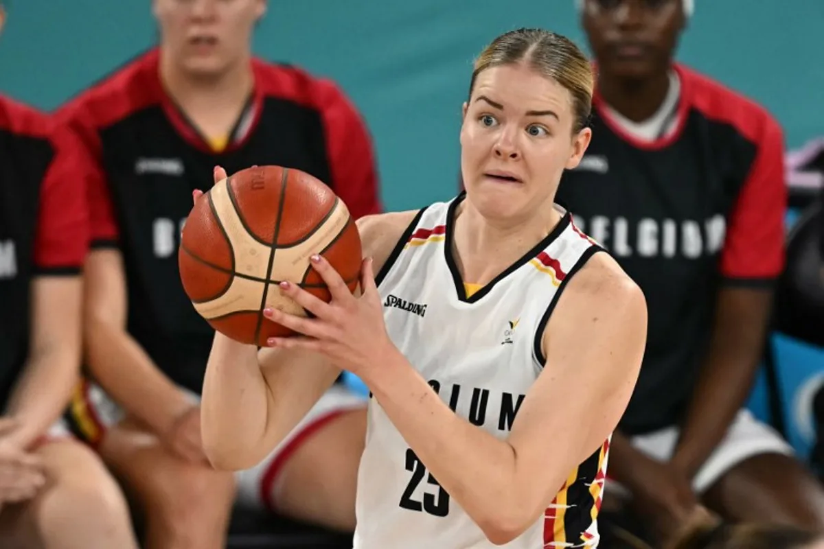 Belgium's #25 Becky Massey reacts as she holds the ball in the women's Bronze Medal basketball match between Belgium and Australia during the Paris 2024 Olympic Games at the Bercy  Arena in Paris on August 11, 2024.  Paul ELLIS / AFP