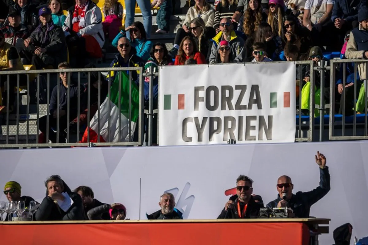 Spectators display a banner in support of France's skier Cyprien Sarrazin, who badly crashed during the last downhill training on December 27, 2024, is seen at the finish line of the Men's Downhill race as part of the FIS Alpine ski World Cup 2024-2025, in Bormio on December 28, 2024. Alexis Monney claimed the first World Cup win of his career on December 298, 2024 after downhill success on a Bormio piste which was heavily criticised following Cyprien Sarrazin's harrowing training crash. Fabrice COFFRINI / AFP