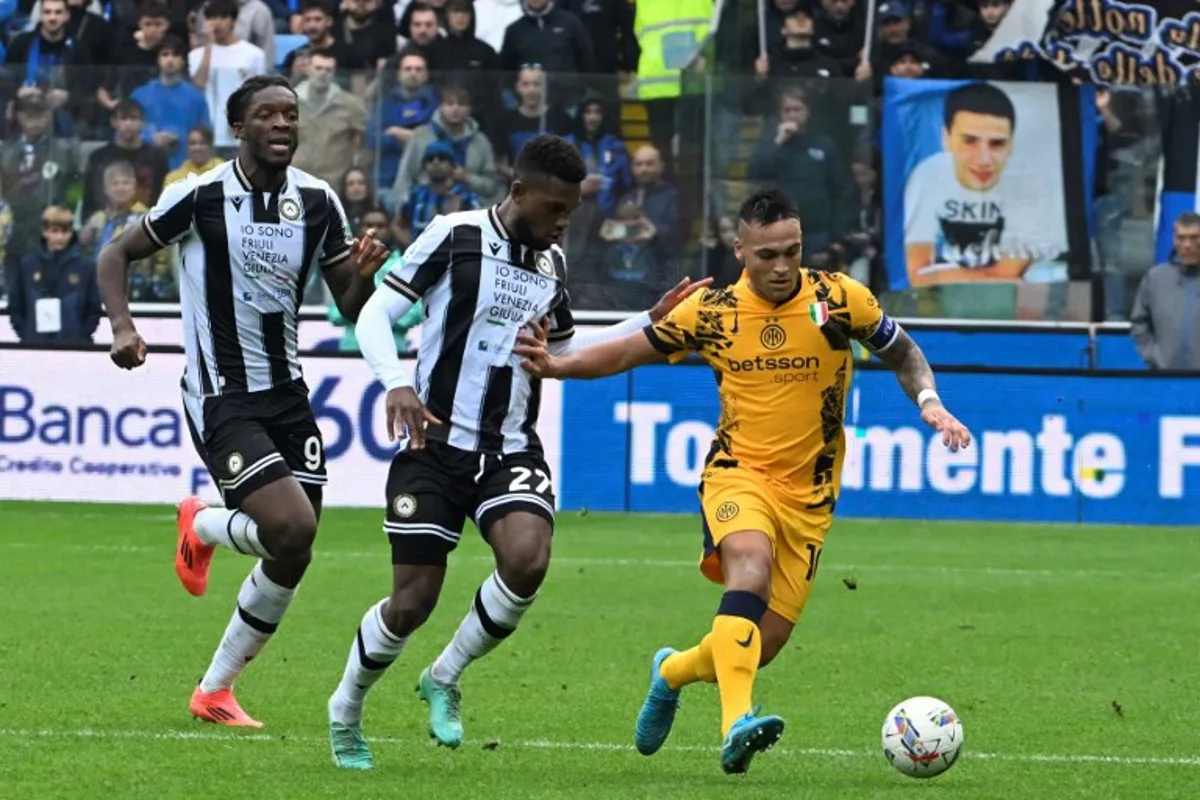 Inter Milan's Argentine forward #10 Lautaro Martinez (R) is chased by Udinese's English forward #09 Keinan Davis and Udinese's Belgian defender #27 Christian Kabasele during the Italian Serie A football match between Udinese and Inter Milan at the Bluenergy Friuli Stadium, in Udine on September 28, 2024.  ANDREA PATTARO / AFP