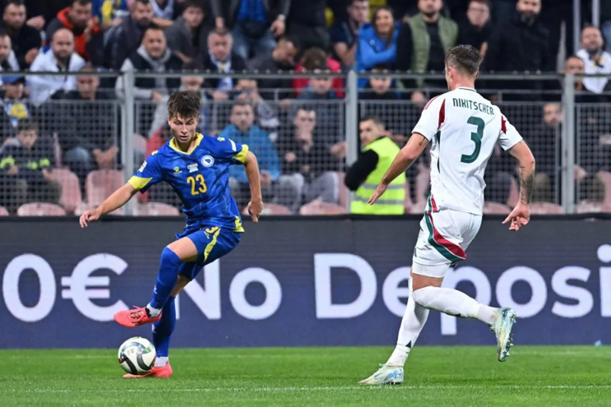 Bosnia and Herzegovina's midfielder #23 Esmir Bajraktarevic (L)  controls the ball next to Hungary's midfielder #03 Tamas Nikitscher during the UEFA Nations League, League A - Group 3, football match between Bosnia and Herzegovina and Hungary at the Bilino Polje Stadium in Zenica, in Zenica, on October 14, 2024.  Elvis Barukcic / AFP