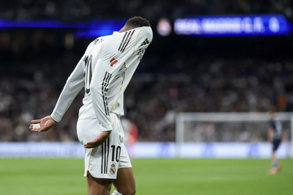 Real Madrid's French forward #10 Kylian Mbappe reacts with his head in his jersey during the Spanish league football match between Real Madrid CF and RC Celta de Vigo at the Santiago Bernabeu Stadium in Madrid on December 7, 2025. Thomas COEX / AFP