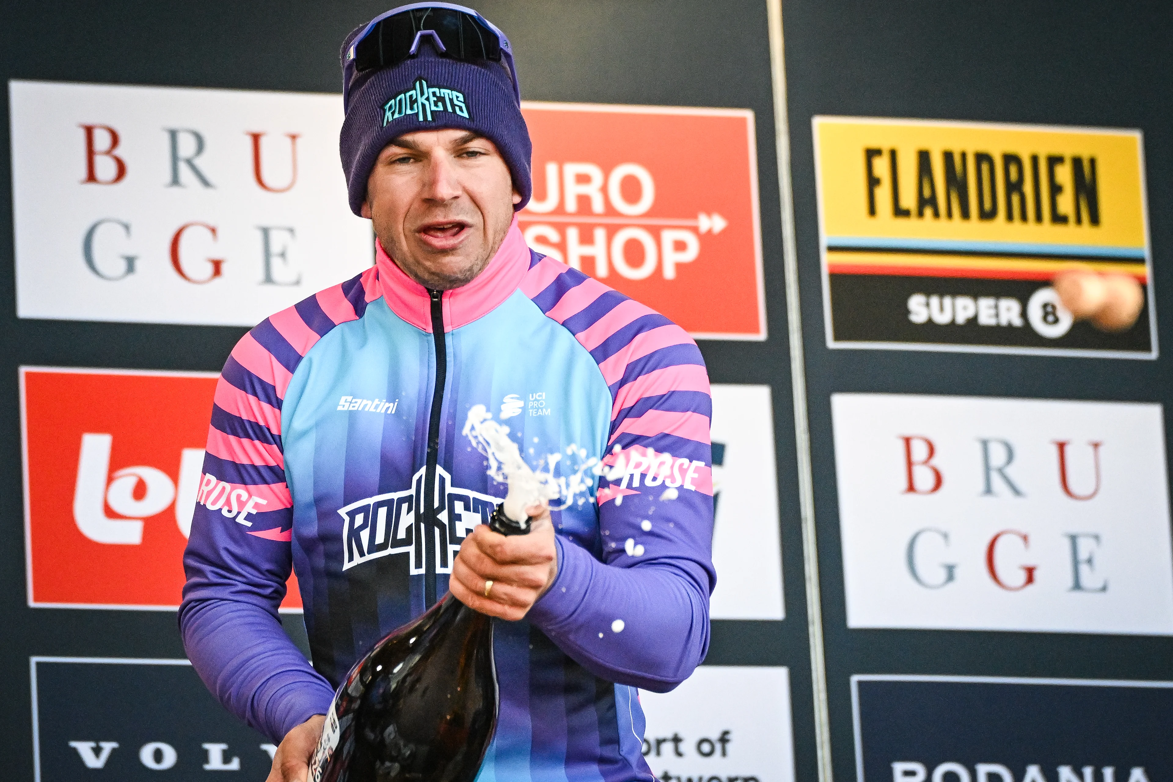 Dutch Dylan Groenewegen of Unibet Rose Rockets celebrates on the podium with champagne after winning the 'Ronde van Brugge' men's elite one-day cycling race, 202,9 km from and to Brugge on Wednesday 25 March 2026. BELGA PHOTO ELIAS ROM