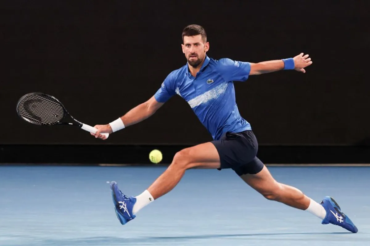 Serbia's Novak Djokovic hits a return against Czech Republic's Jiri Lehecka during their men's singles match on day eight of the Australian Open tennis tournament in Melbourne on January 19, 2025.  DAVID GRAY / AFP