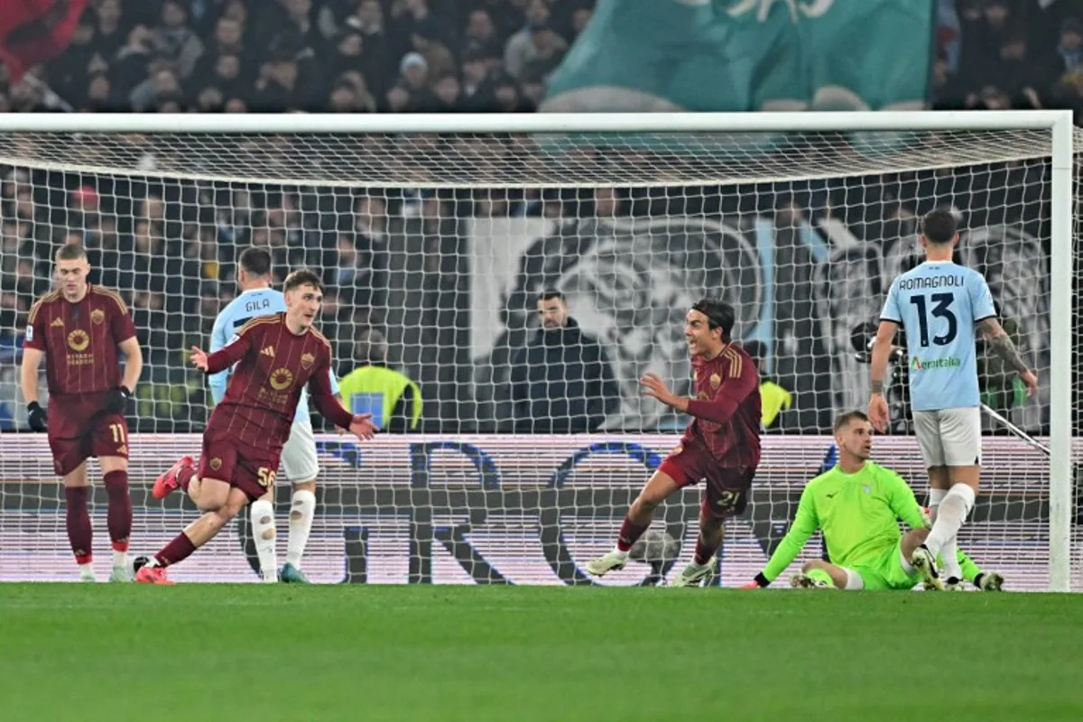 Roma Belgian's forward #56 Alexis Saelemaekers (3L) celebrates after scoring a goal during the Italian Serie A football match between Roma and Lazio, at the Olympic stadium in Rome on January 5, 2025.  Andreas SOLARO / AFP