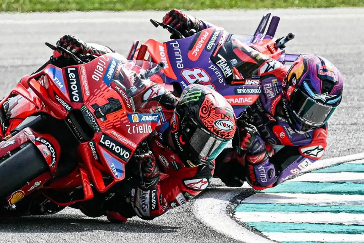 Ducati Lenovo Team's Italian rider Francesco Bagnaia (L) and Prima Pramac Racing's Spanish rider Jorge Martin compete during the MotoGP Malaysian Grand Prix at the Sepang International Circuit in Sepang on November 3, 2024.  MOHD RASFAN / AFP