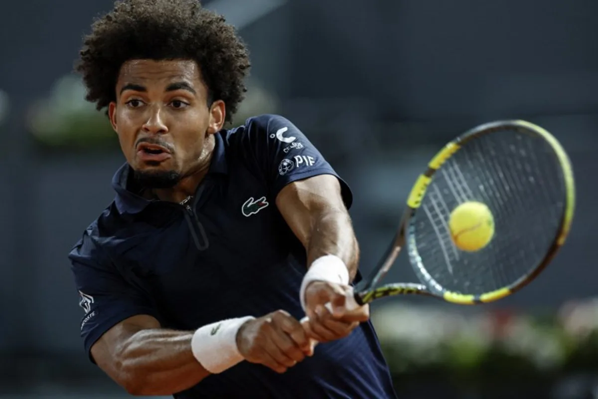 France's Arthur Fils returns the ball to Czech Republic's Jiri Lehecka during their 2026 ATP Tour Madrid Open tennis tournament quarterfinal singles match at the Caja Magica in Madrid, on April 29, 2026.  OSCAR DEL POZO / AFP