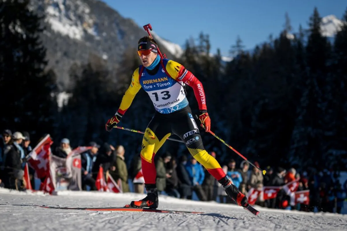 Belgium Florent Claude #13 competes in the men's 12,5 km pursuit event of the IBU Biathlon World Cup in Lenzerheide on December 16, 2023. Fabrice COFFRINI / AFP