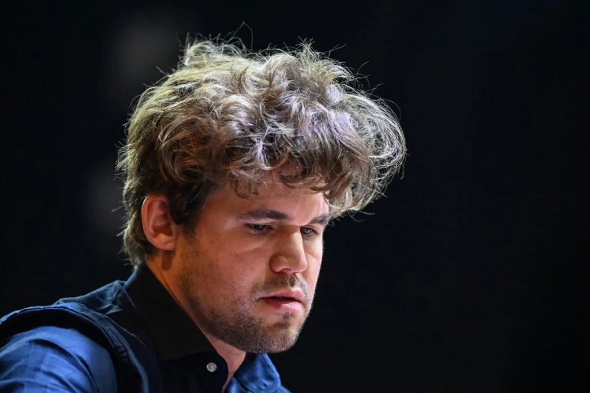 Norway's chess grandmaster Magnus Carlsen gestures during a game in the Tata Steel Chess India tournament in Kolkata on November 17, 2024.  DIBYANGSHU SARKAR / AFP