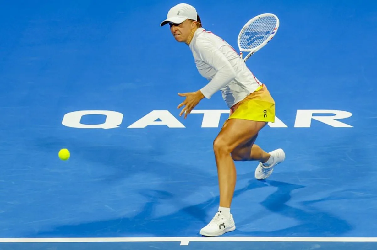 Poland's Iga Swiatek retruns a shot to Latvia's Jelena Ostapenko during their 2025 WTA Qatar Open semi-final tennis match at the Khalifa International Tennis Complex in Doha on February 14, 2025.  KARIM JAAFAR / AFP