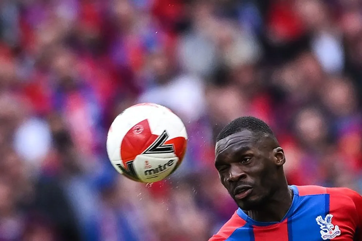 Crystal Palace's Zaire-born Belgian striker Christian Benteke heads the ball during the English FA Cup semi-final football match between Chelsea and Crystal Palace at Wembley Stadium in north west London on April 17, 2022.   Ben Stansall / AFP