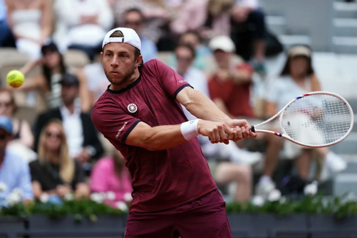 Netherlands' Tallon Griekspoor plays a backhand return to Germany's Alexander Zverev during their men's singles match on day 9 of the French Open tennis tournament on Court Suzanne-Lenglen at the Roland-Garros Complex in Paris on June 2, 2025. Dimitar DILKOFF / AFP